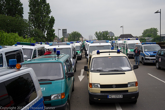 four lane road full of police vehicles as far as the eye can see